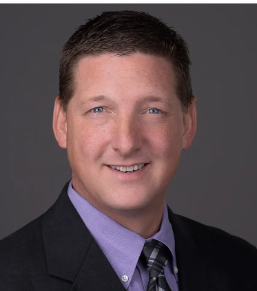 James Oliver, CEO of Brickwell Housing, professional headshot in business attire